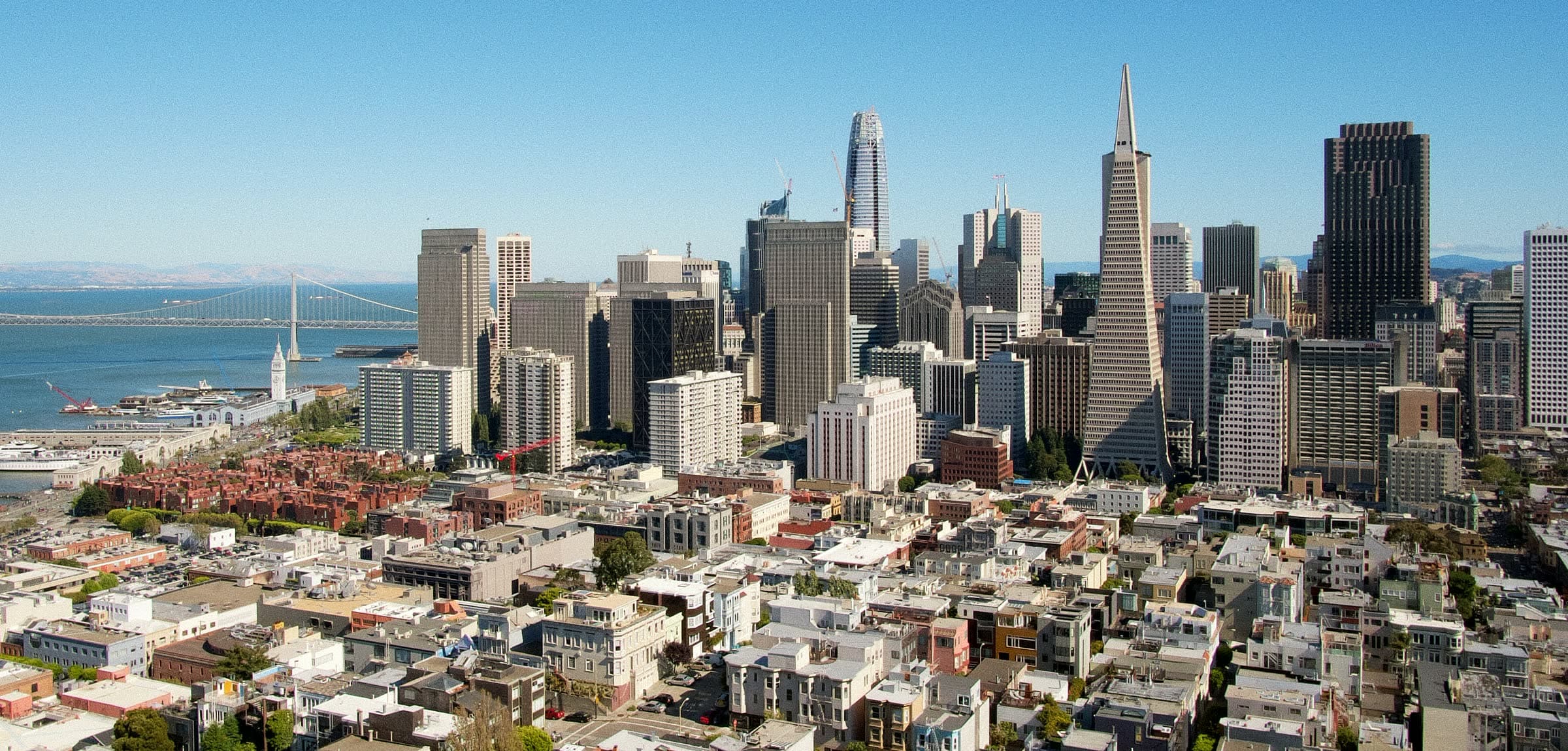 Downtown San Francisco from above, with North Beach rooftops in the foreground