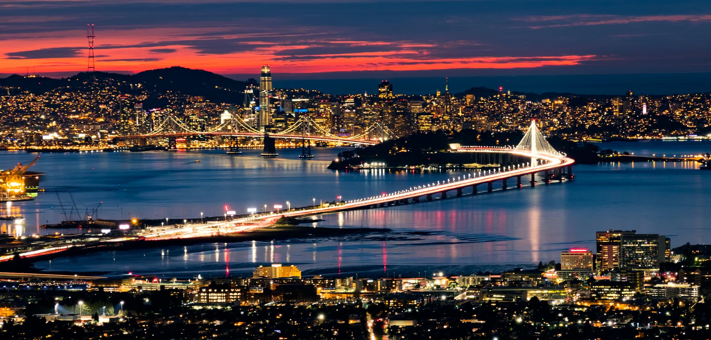 San Francisco and the Bay Bridge at dusk, seen across the bay